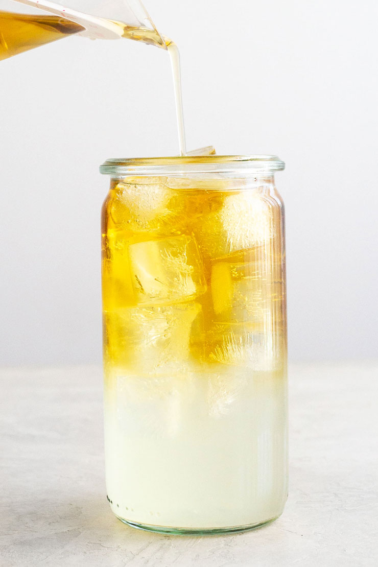 Pouring iced tea into lemonade