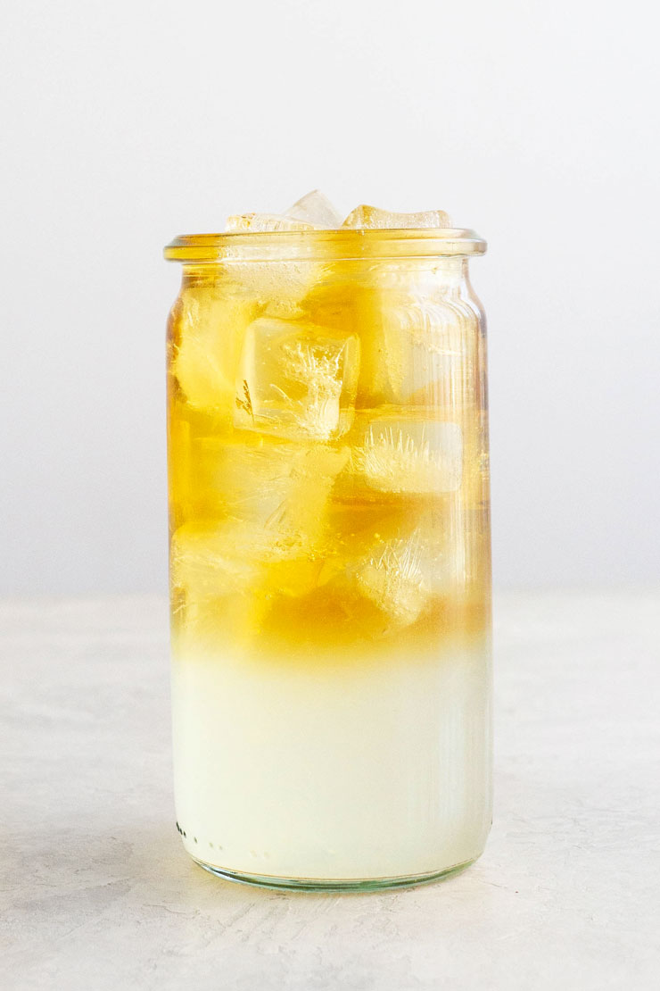 Layered Arnold Palmer drink with lemonade and iced tea in a cup with ice