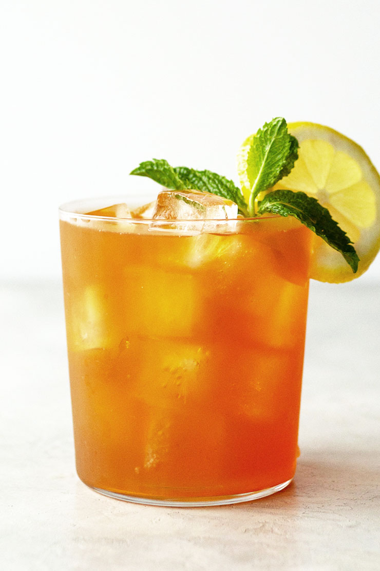 Ice Chilled Iced Tea in a cup with fresh mint and lemon slice garnish.
