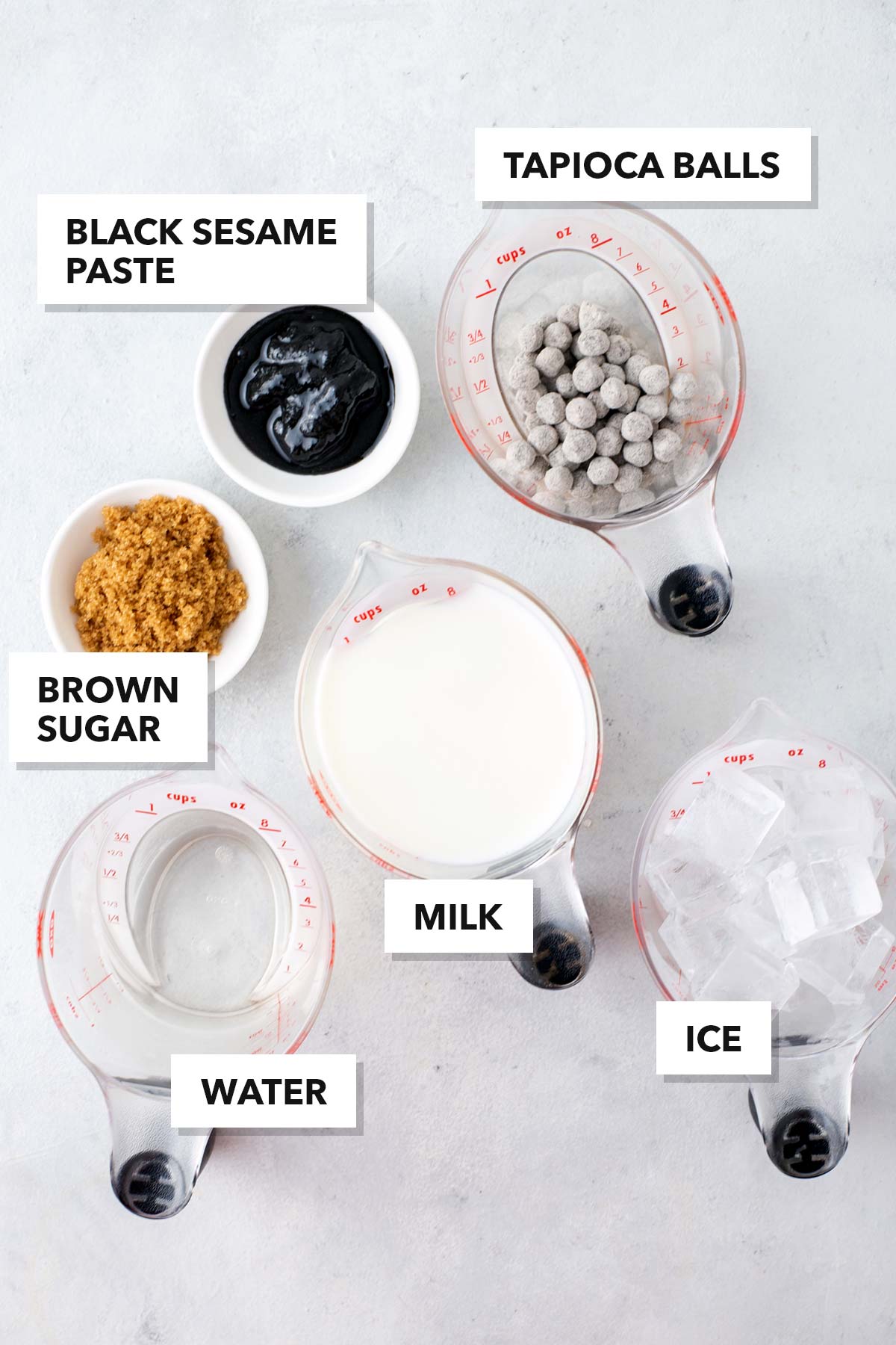 Black Sesame Bubble Tea ingredients measured in cups and labeled on a table.