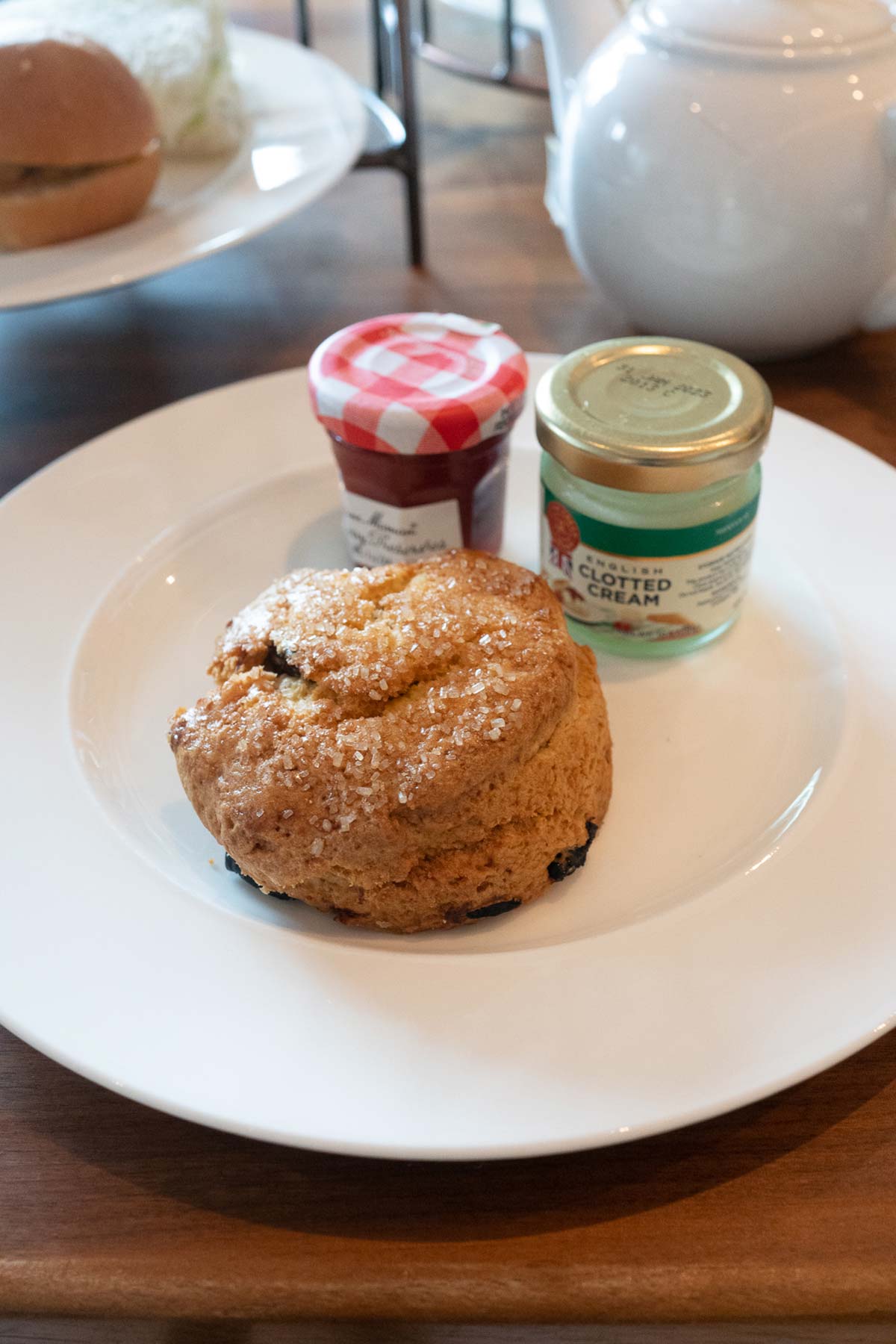 Scone with condiments in jars at Bluebird London NYC