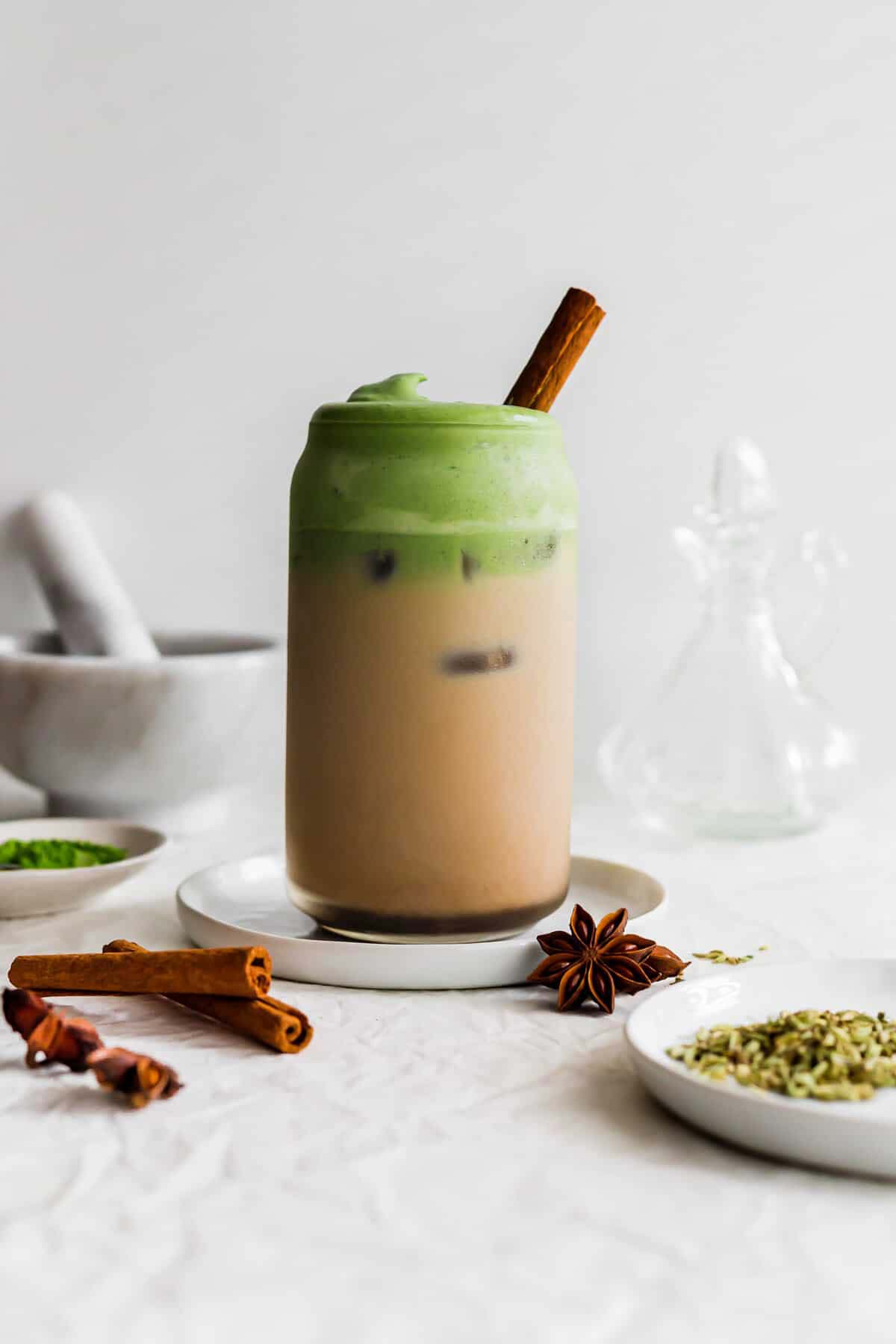 A layered Iced Matcha Chai Latte in a glass.