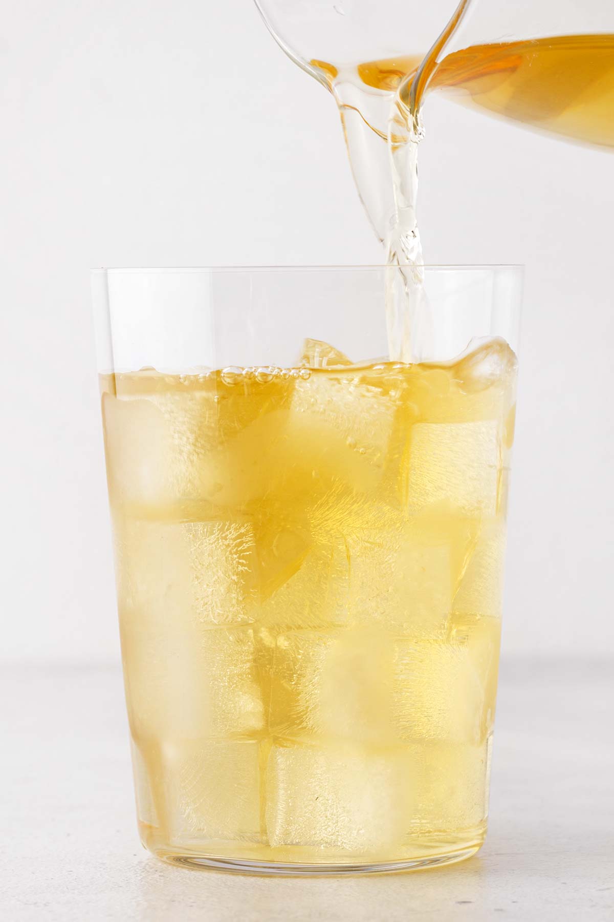 Chamomile Iced Tea being poured into clear glass.