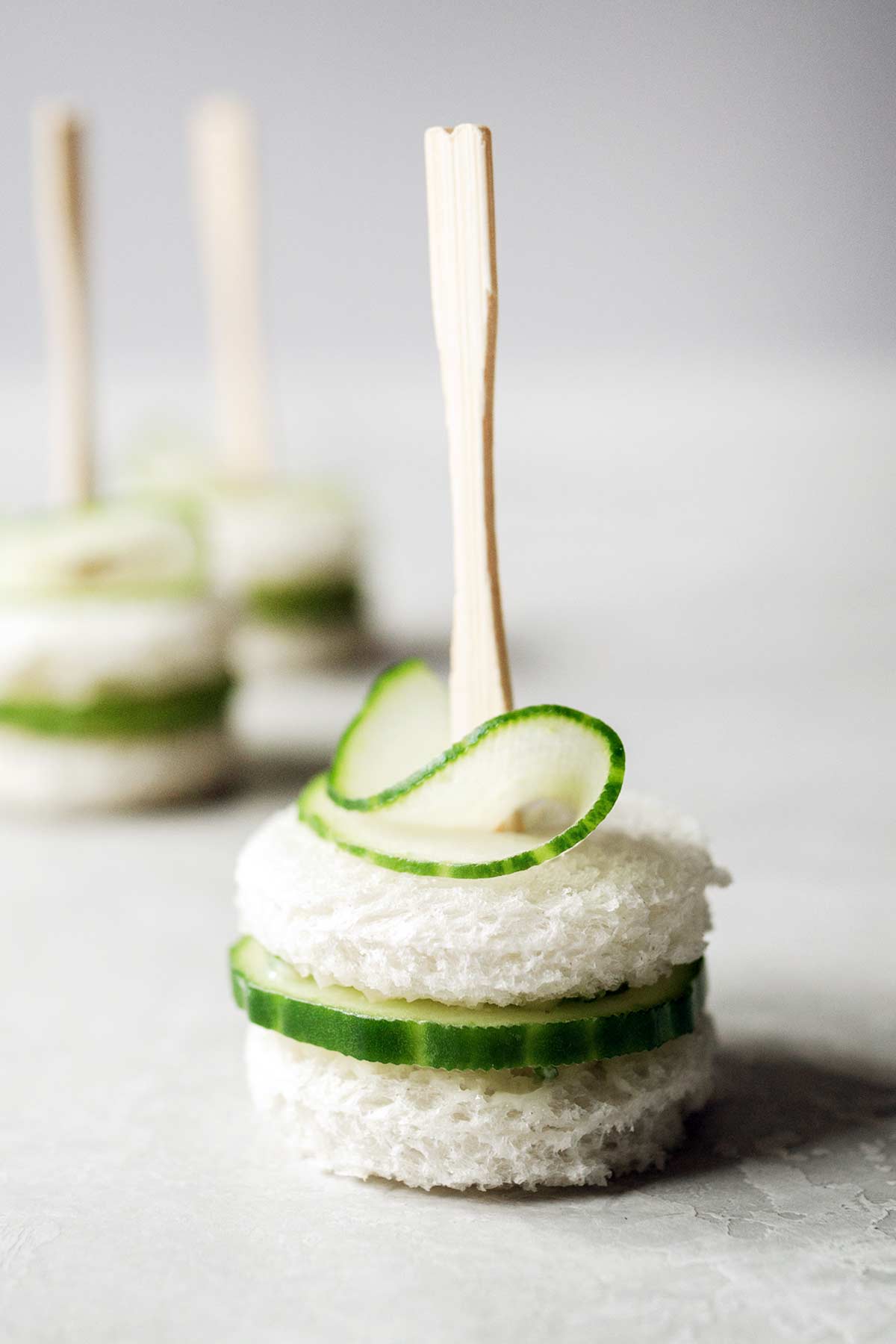 Cucumber tea sandwiches skewered with cocktail forks.