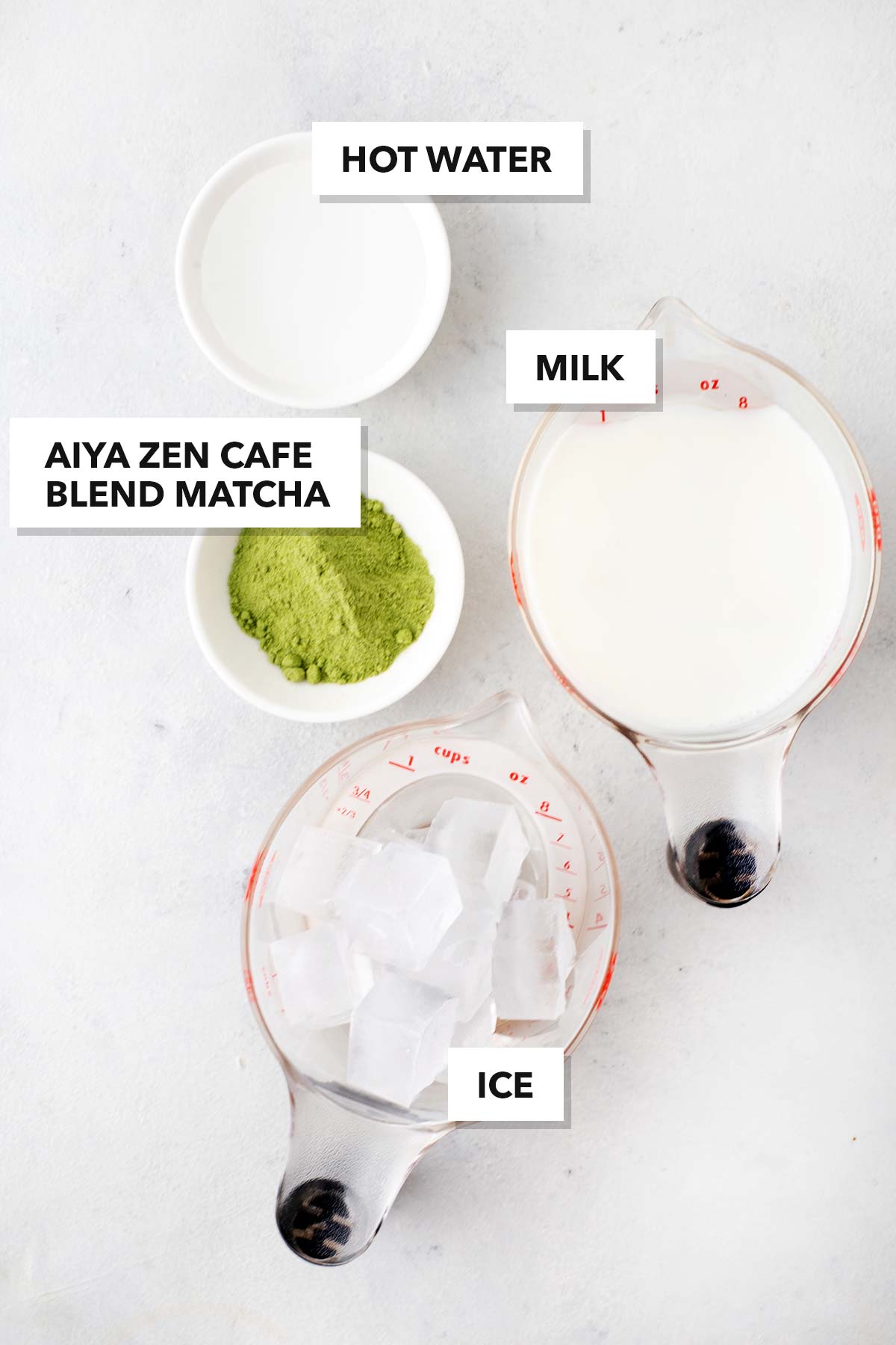 Dunkin' Iced Matcha Latte Copycat ingredients measured in cups and labeled on a table.