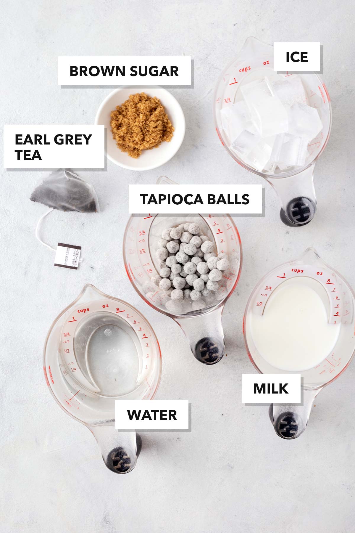 Earl Grey Bubble Tea (Earl Grey Boba Milk Tea) ingredients measured in cups and labeled on a table.