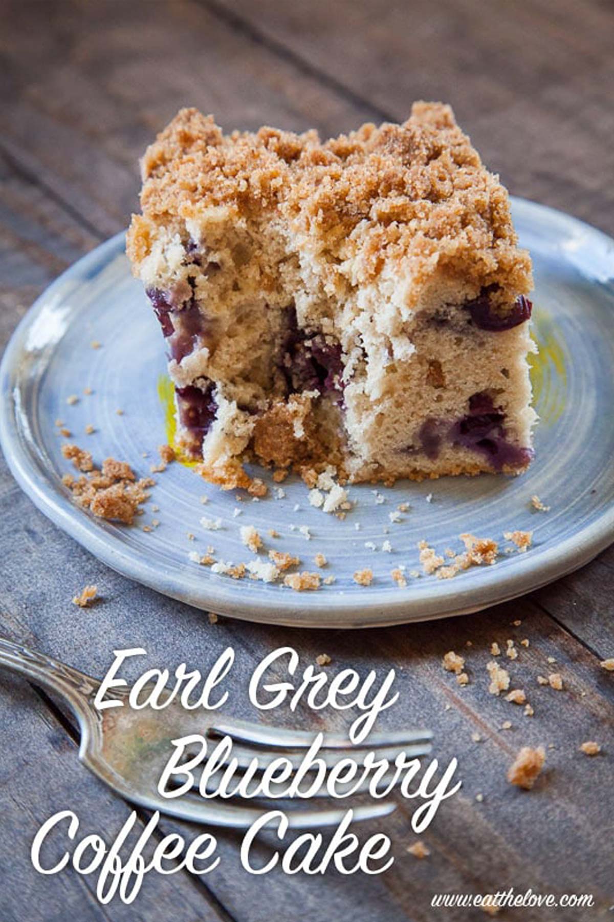 Earl Grey Blueberry Coffee Cake on a plate on a wooden table.
