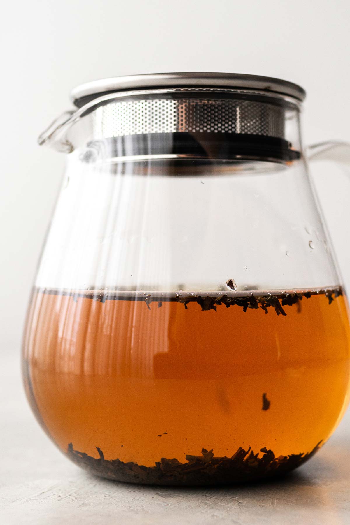 Black tea in a glass teapot.