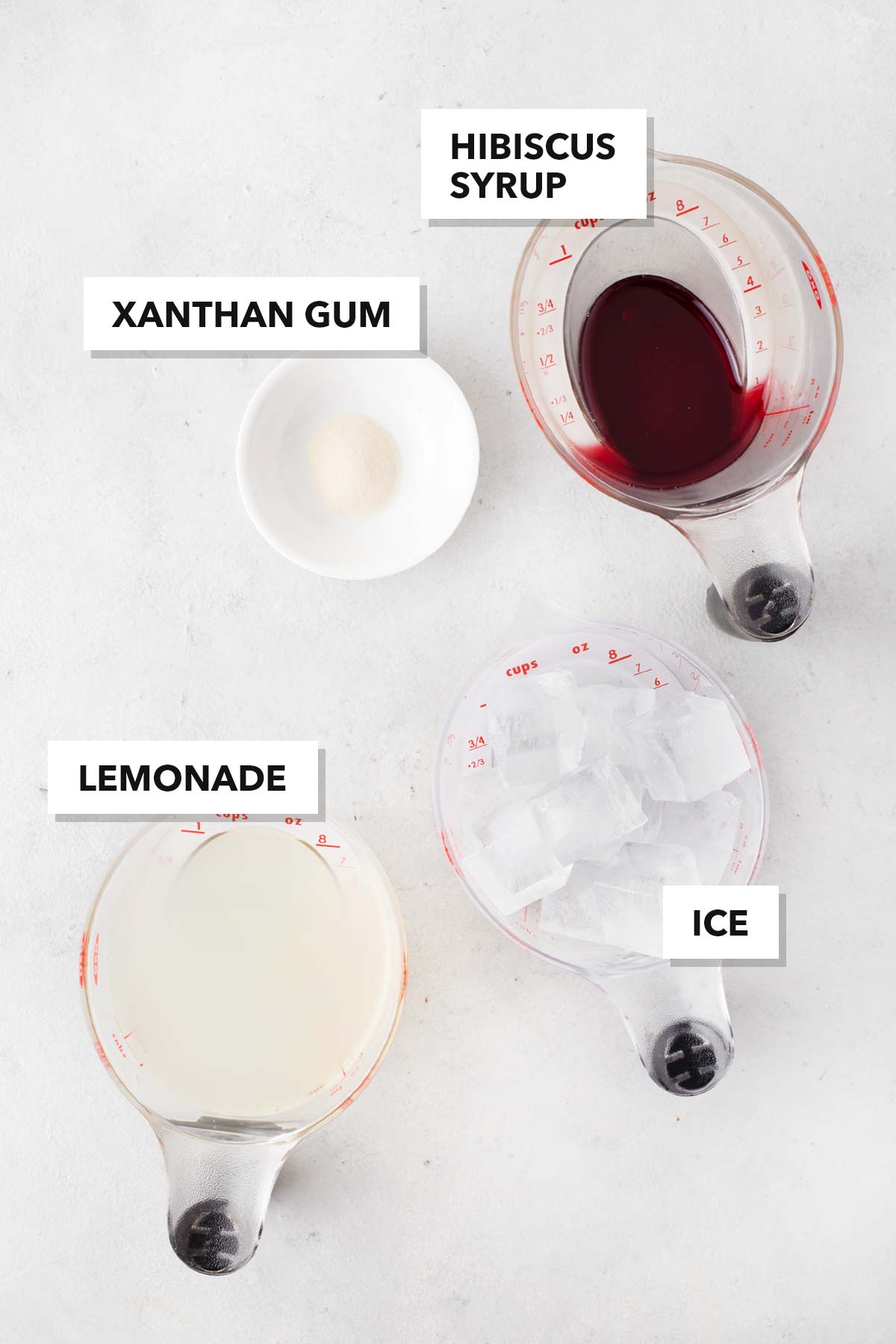 Ingredients for Frozen Hibiscus Lemonade measured in cups and bowls.