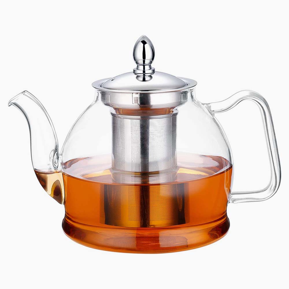 Glass teapot with a stainless steel lid and infuser with tea inside.