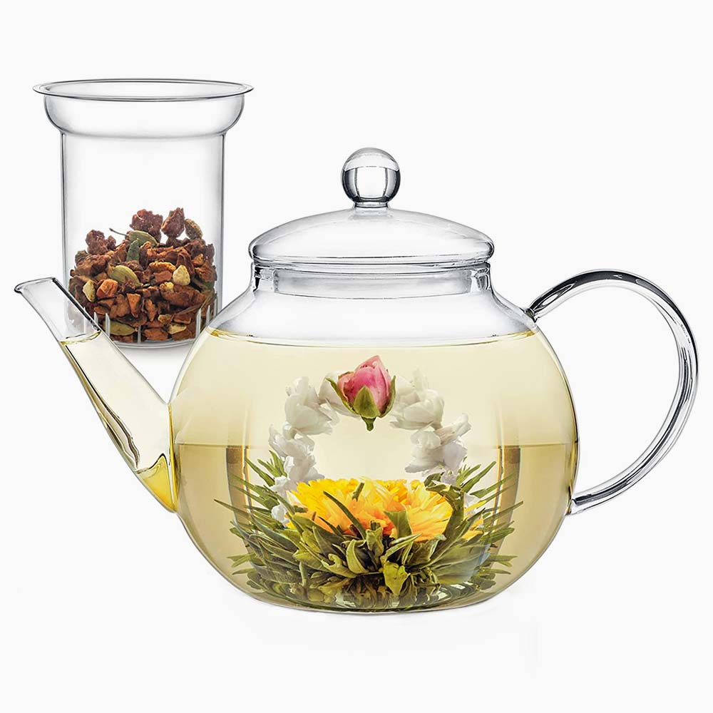 Glass teapot with flowering tea steeped in water.