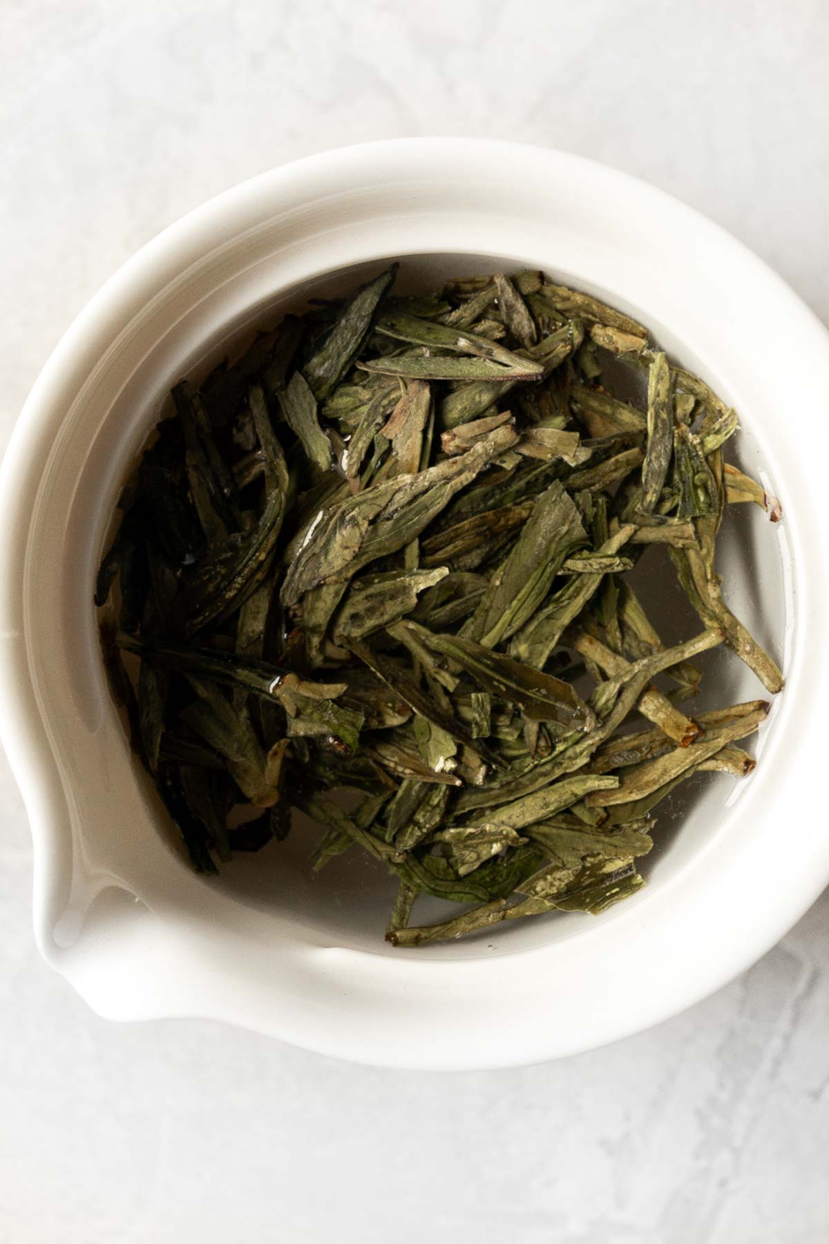 Green tea in a white gaiwan.