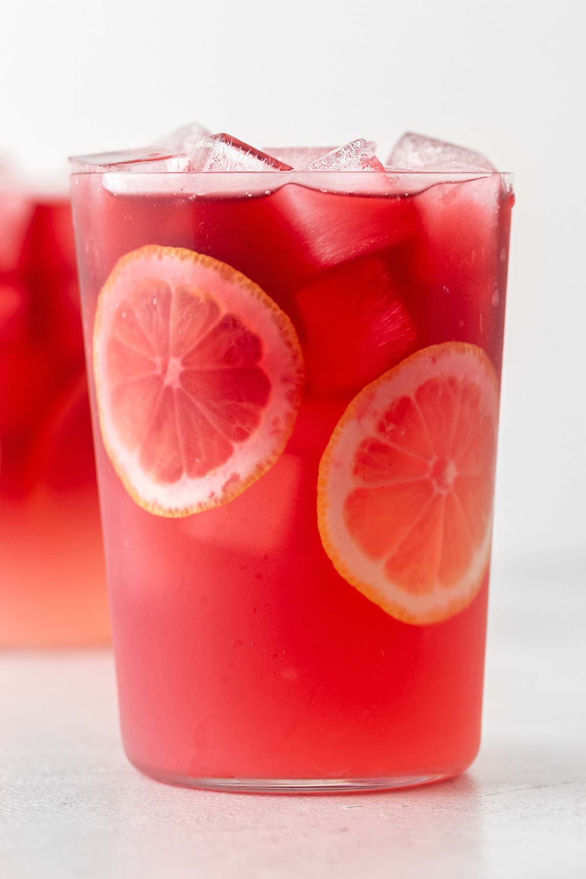 Hibiscus Lemonade In clear glass.