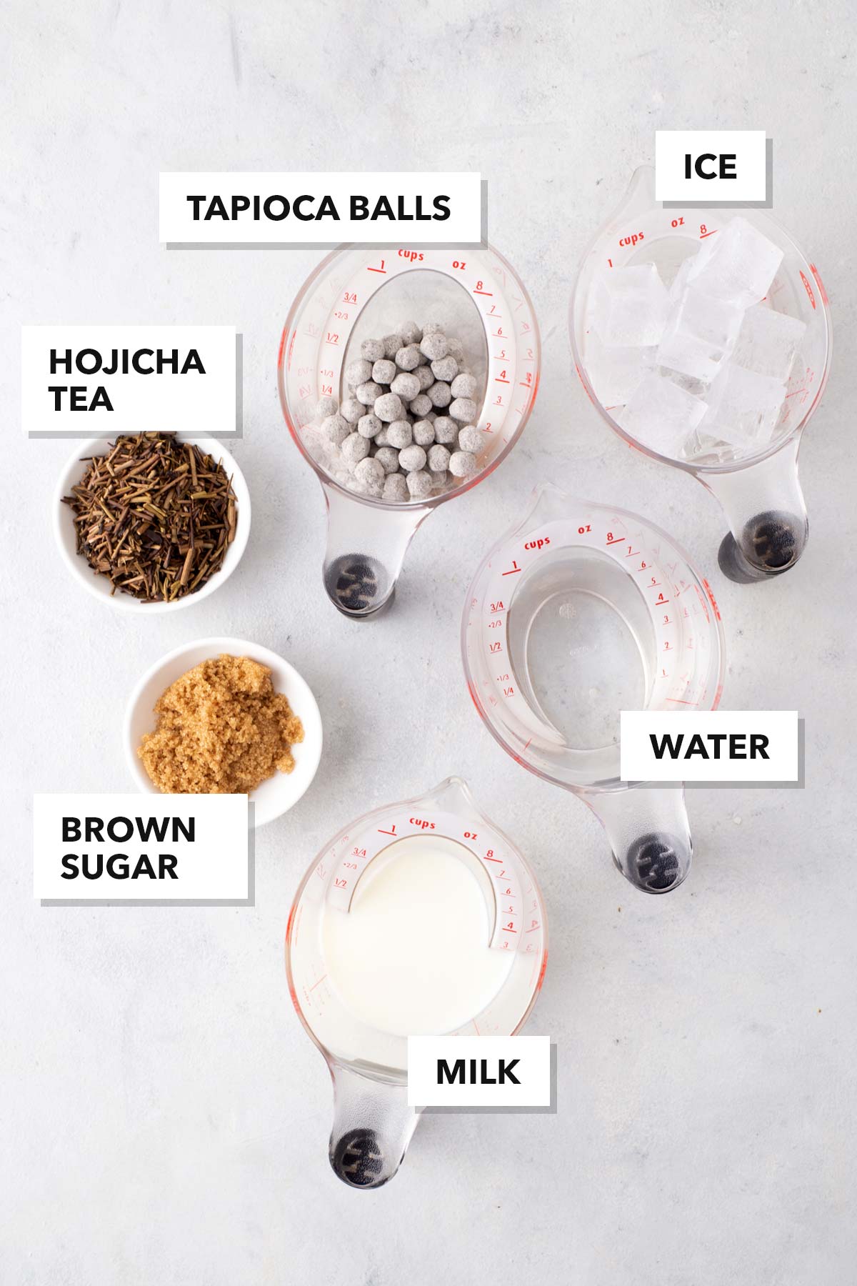 Hojicha Bubble Tea (Hojicha Boba Milk Tea) ingredients measured in cups and labeled on a table.