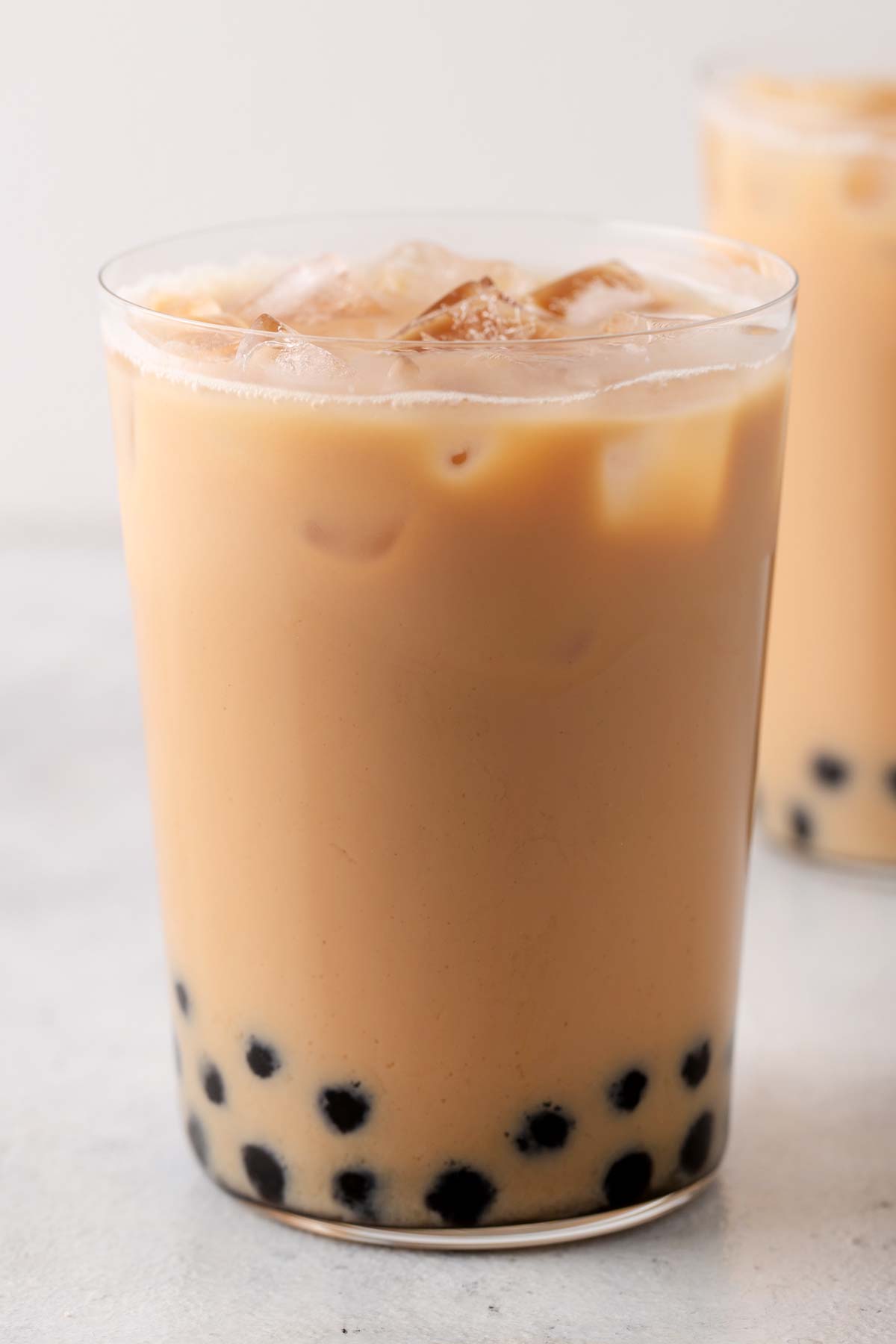 A ready to drink Hong Kong Milk Tea (Hong Kong Bubble Tea) in a tall, clear glass.
