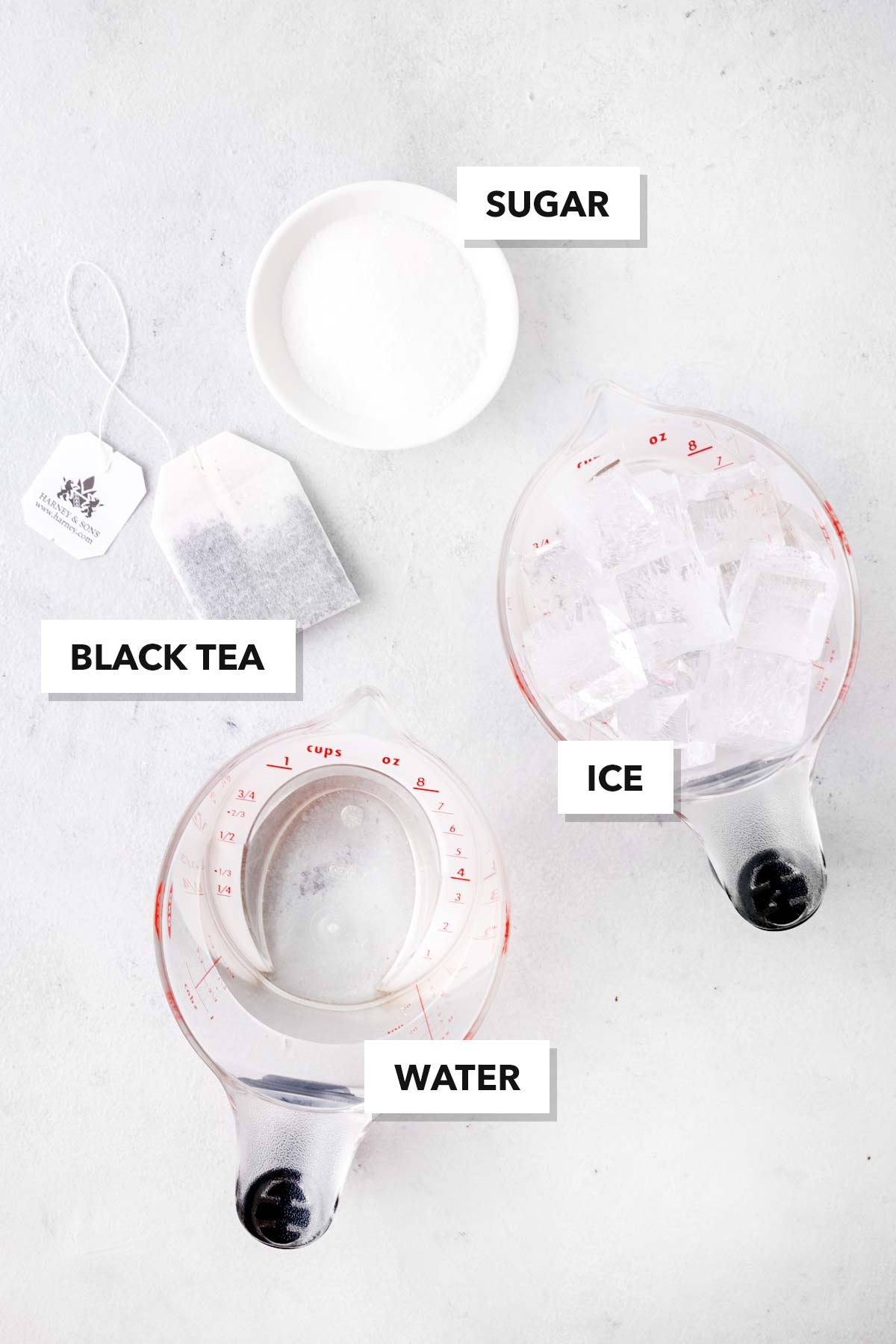 Black Iced Tea ingredients, labeled, on a white tabletop.