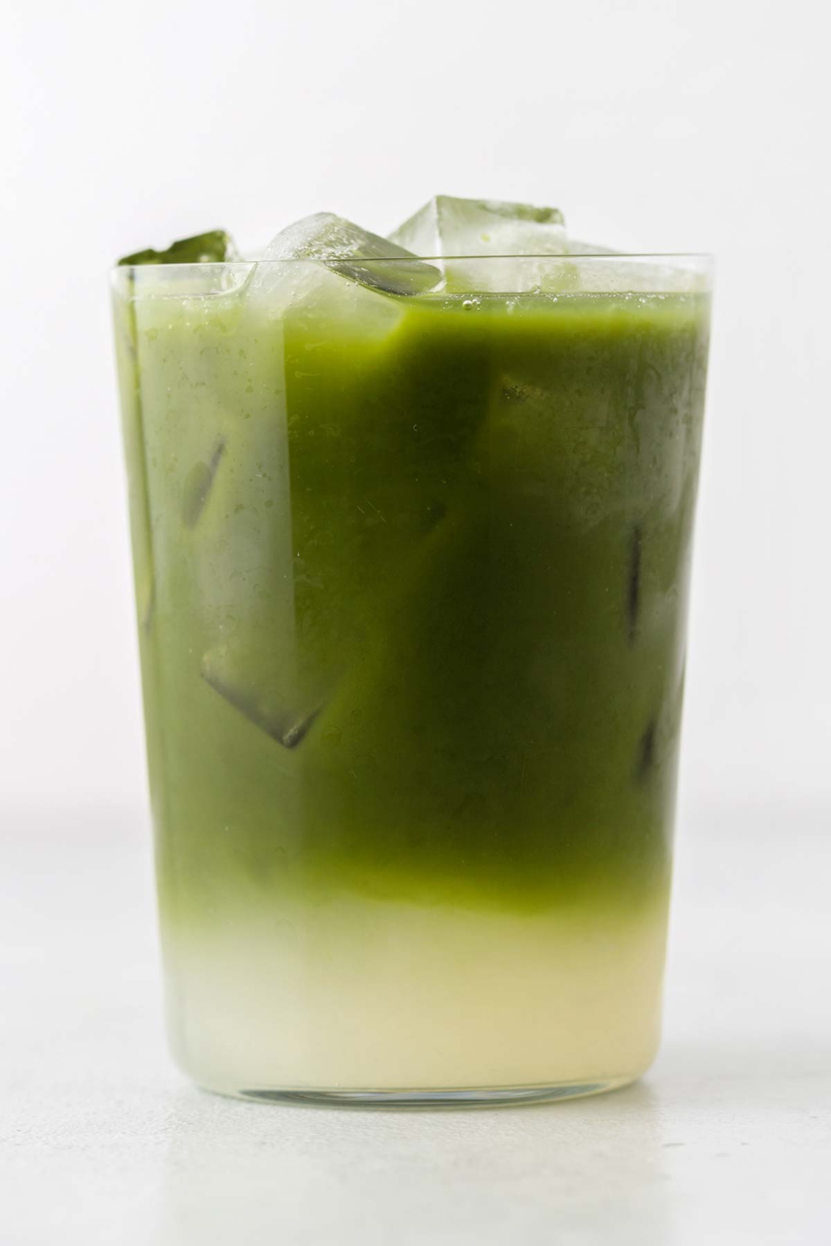 Matcha lemonade in a glass with ice.