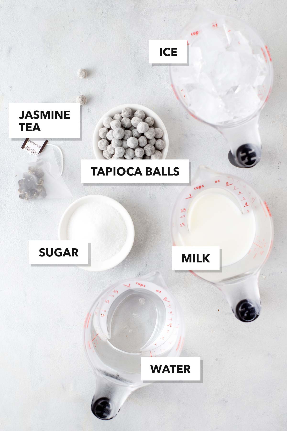 Jasmine Green Bubble Tea ingredients in measuring cups and bowls.
