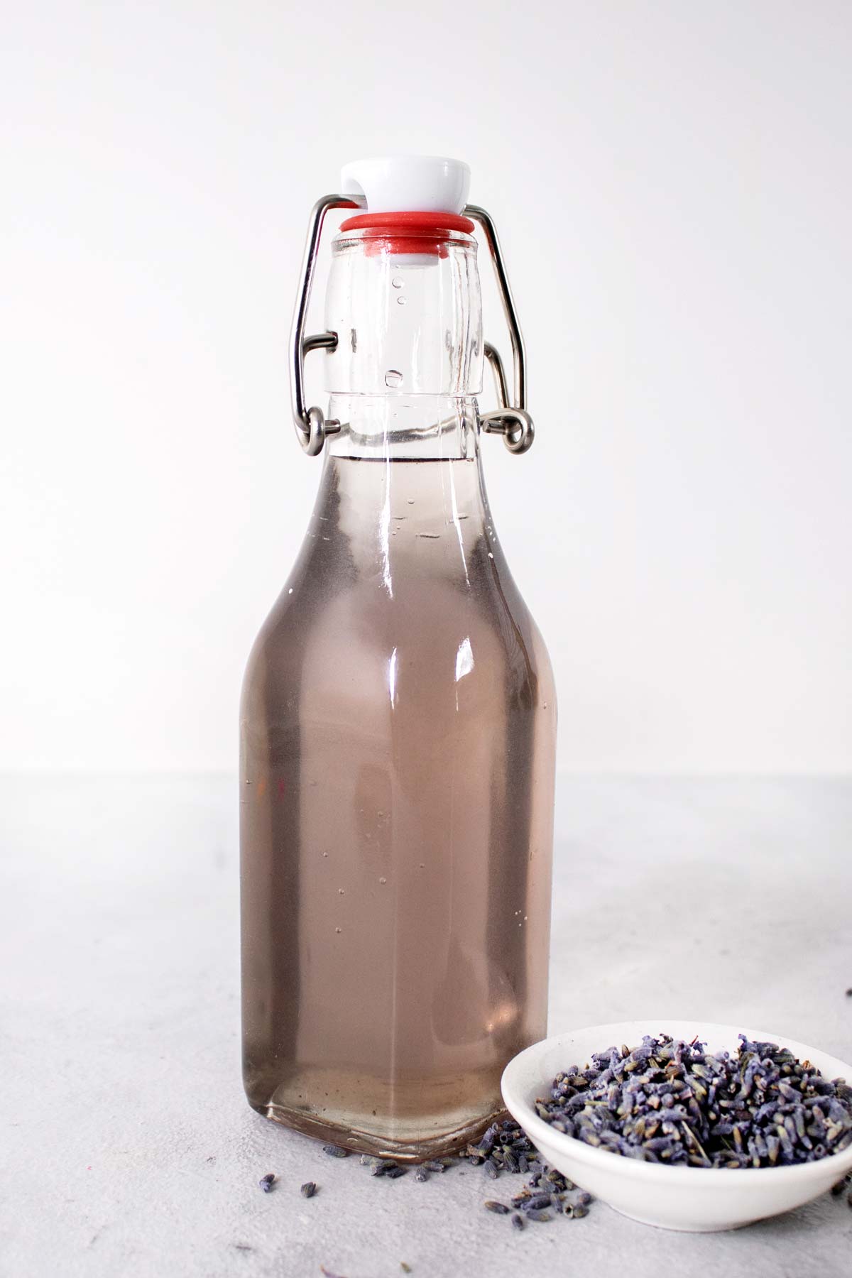 Lavender simple syrup in a glass bottle.