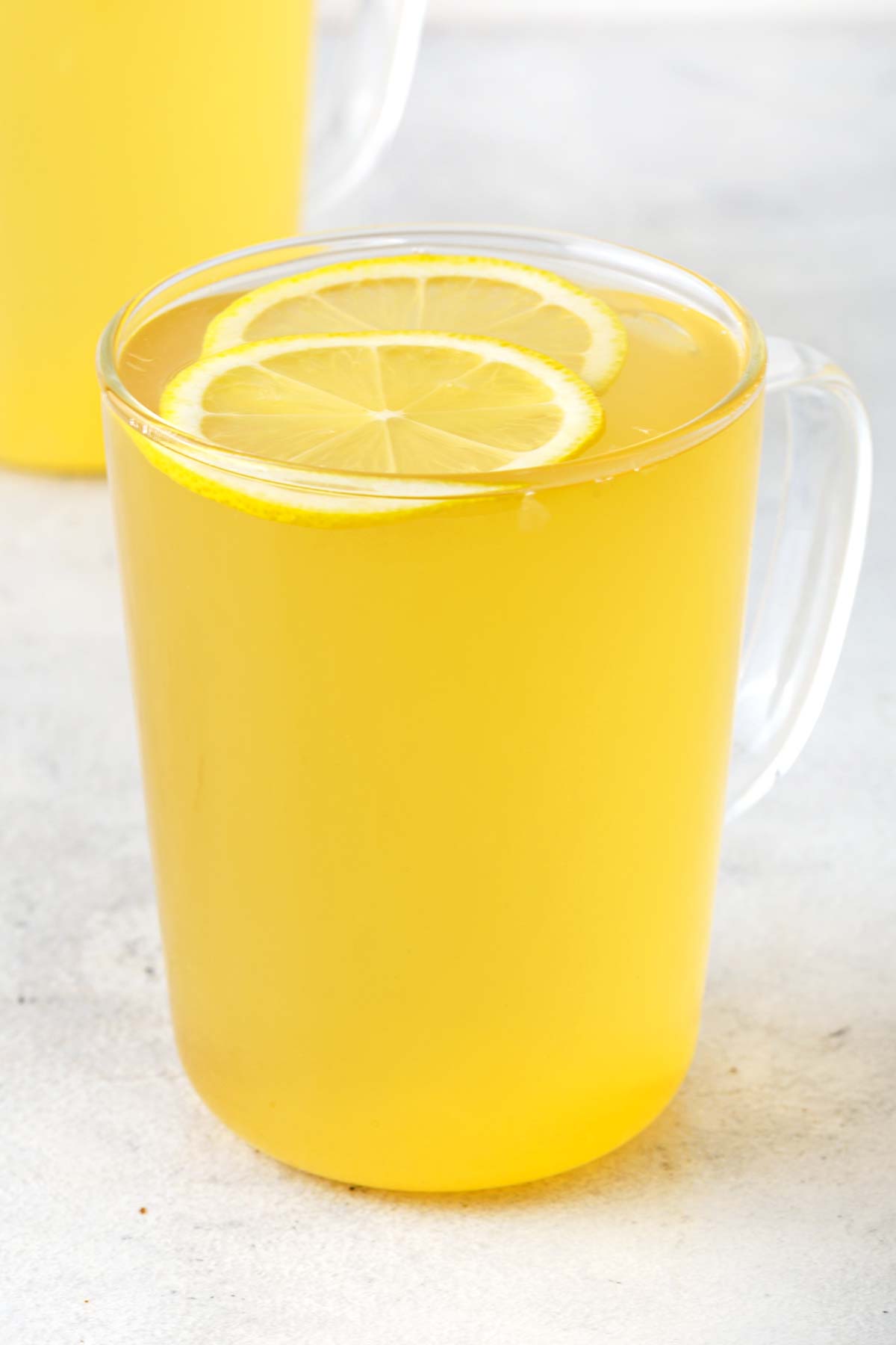 Lemon Tea with lemon slices in clear mug.