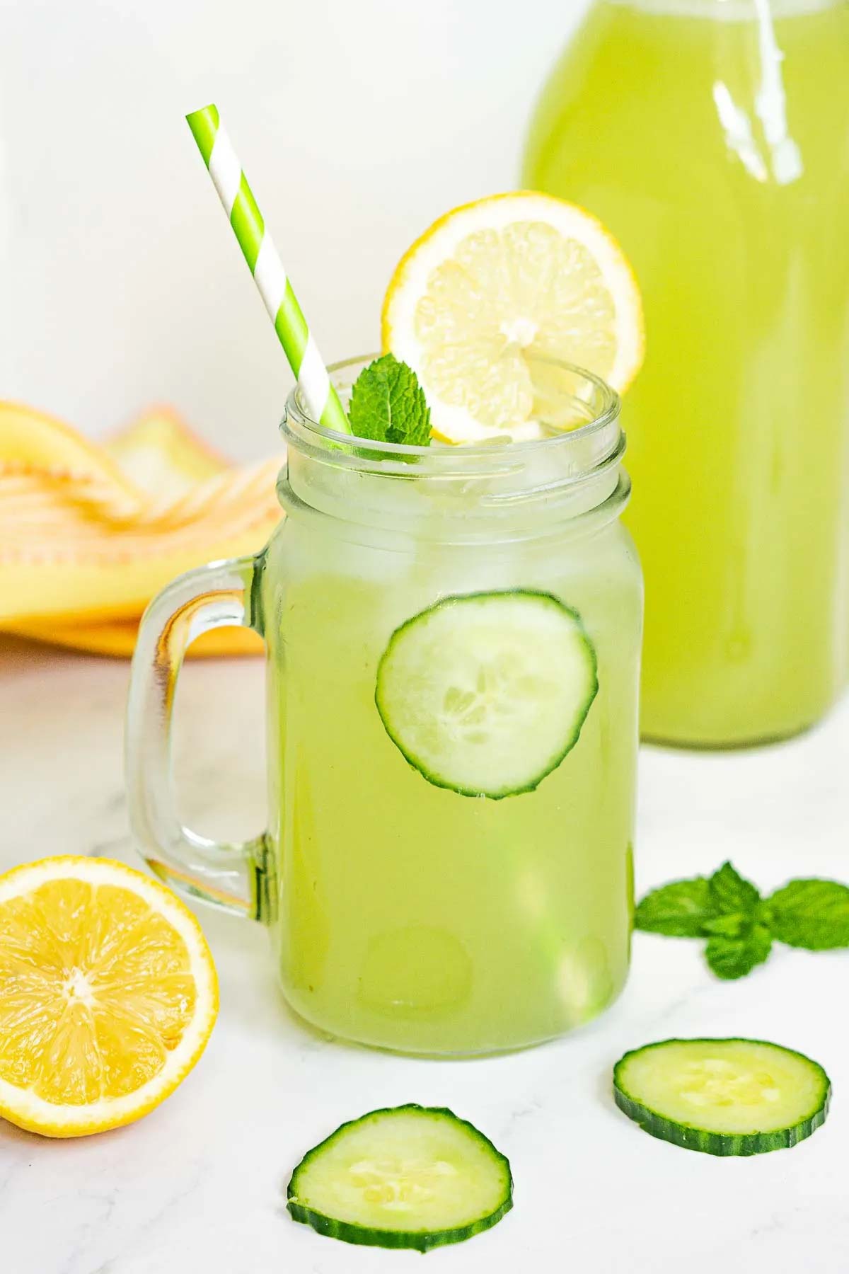 Cucumber Lemonade in a mason jar cup.