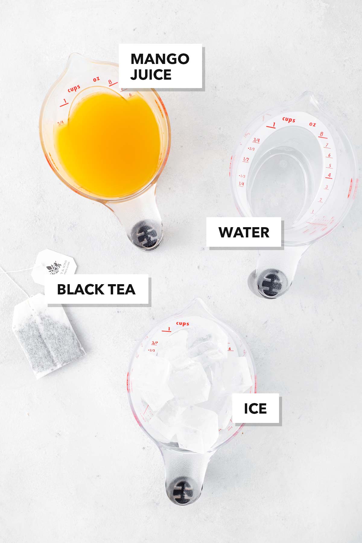 Ingredients for Mango Iced Tea measured out in bowls and cups.
