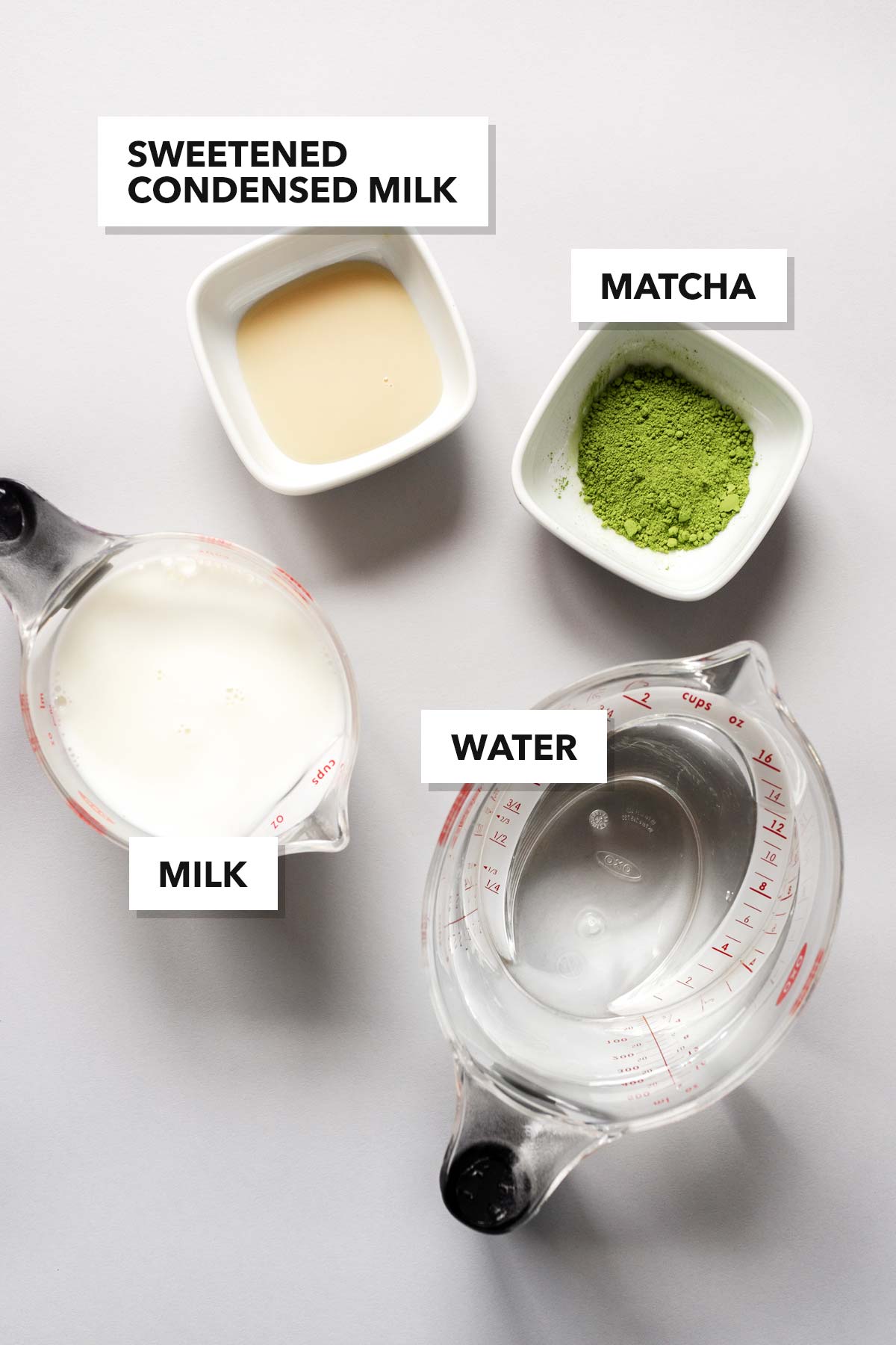 Matcha latte ice cube ingredients on a surface.
