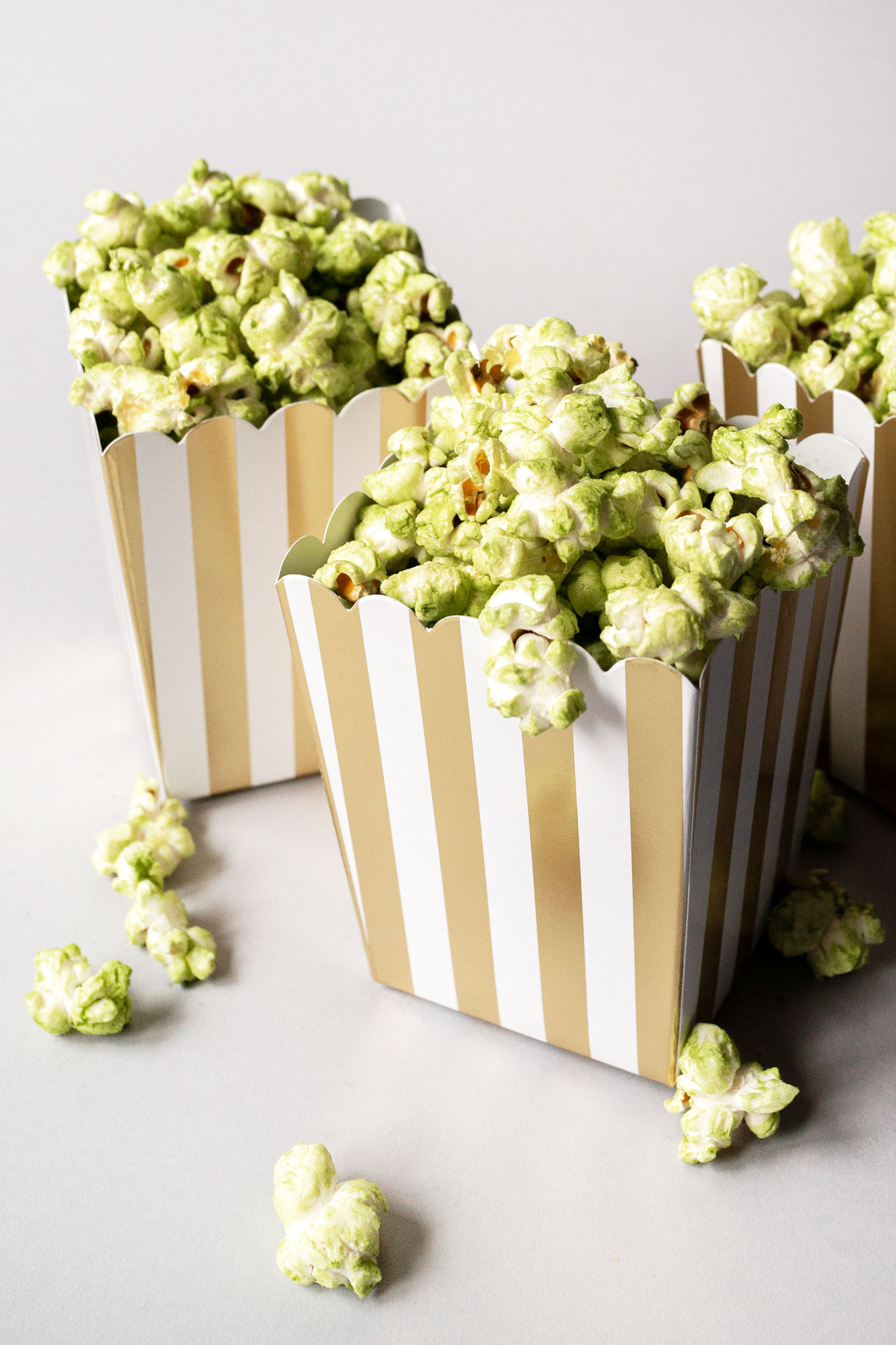 Matcha popcorn in paper popcorn containers.