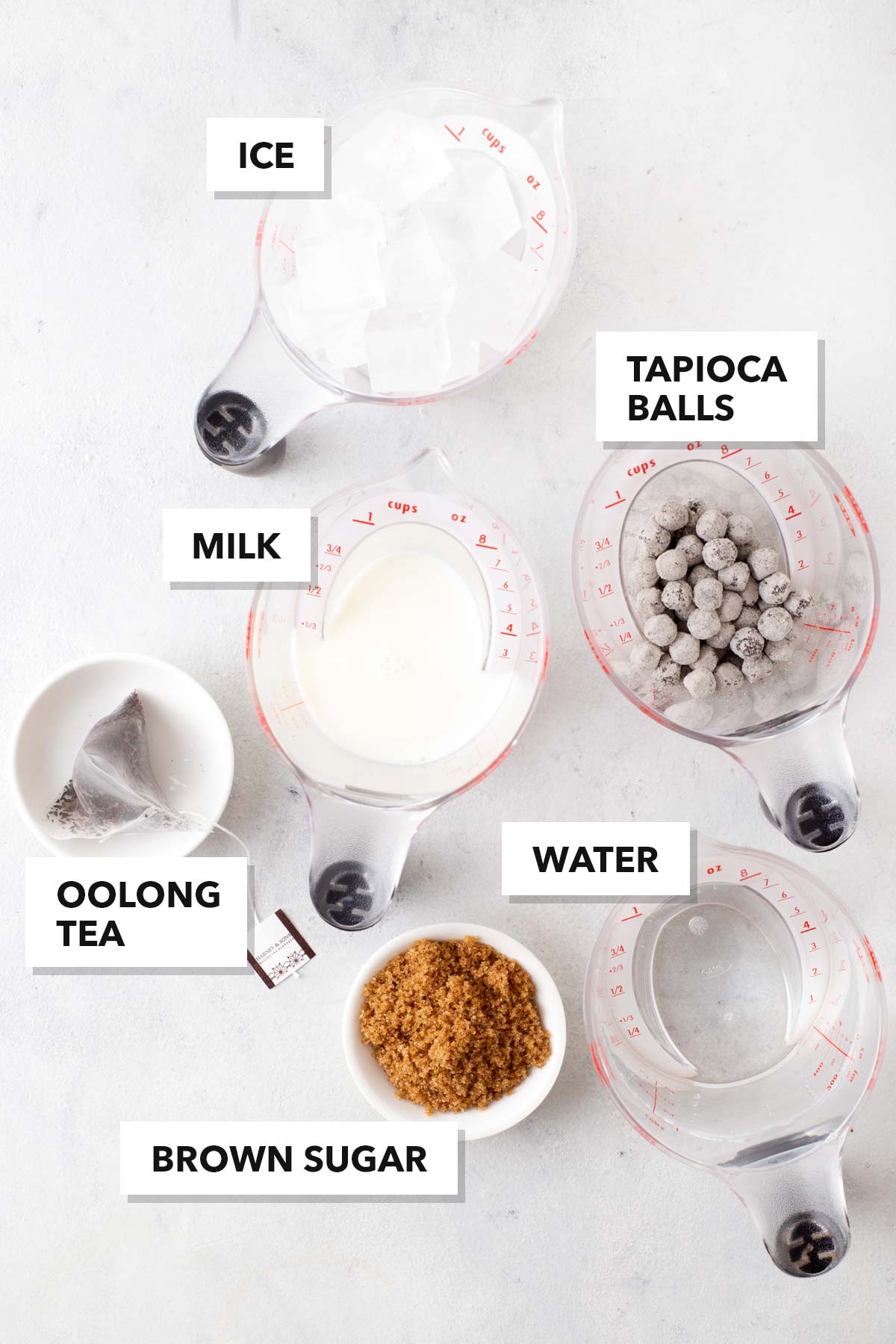Oolong Bubble Tea ingredients in measuring cups on a table.