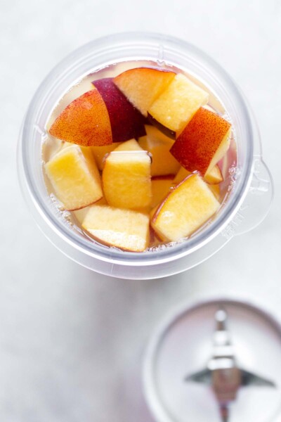 Peaches in a blender cup. 