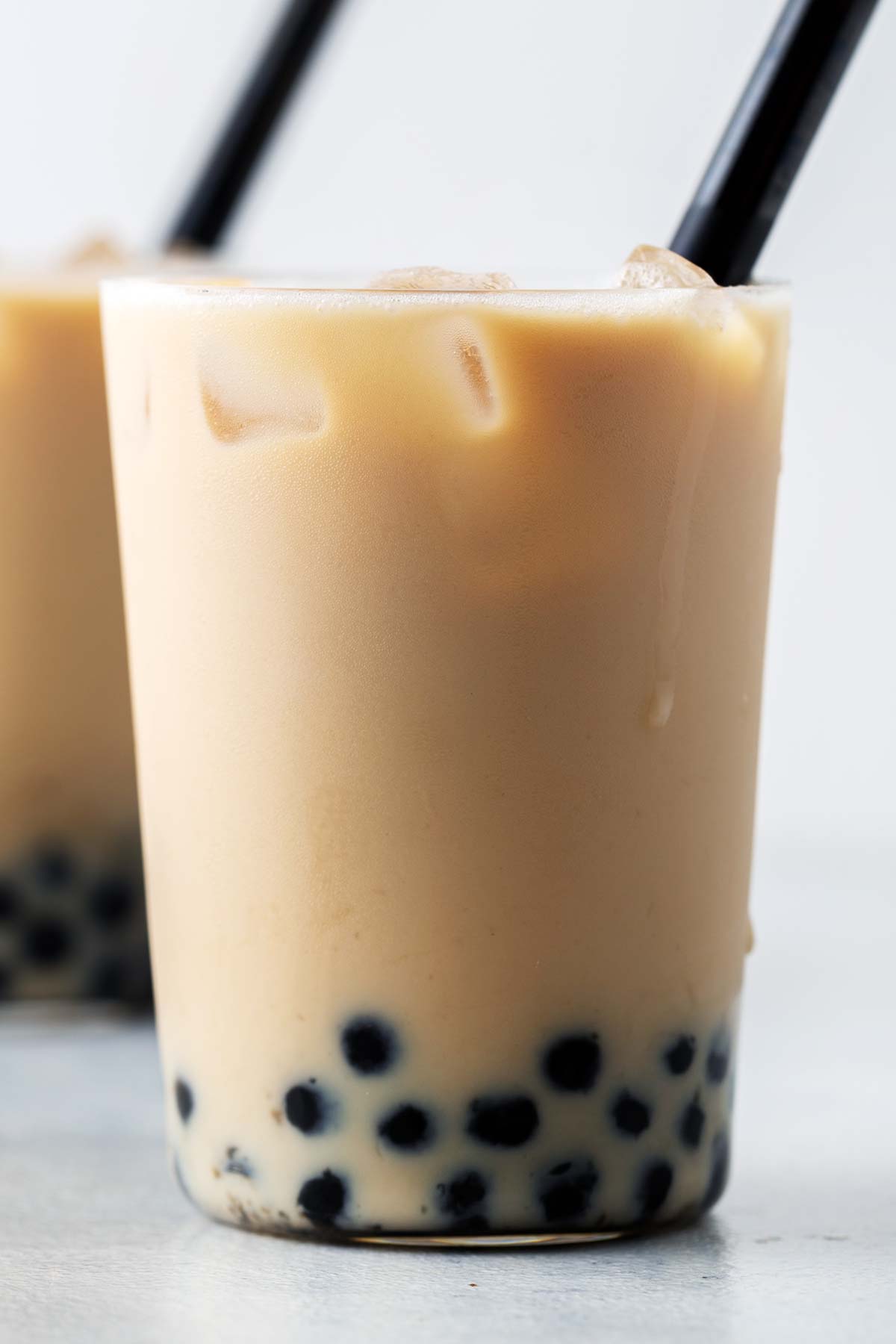 Rose Bubble Tea (Rose Milk Tea with Boba) fully assembled and mixed in a large clear glass.