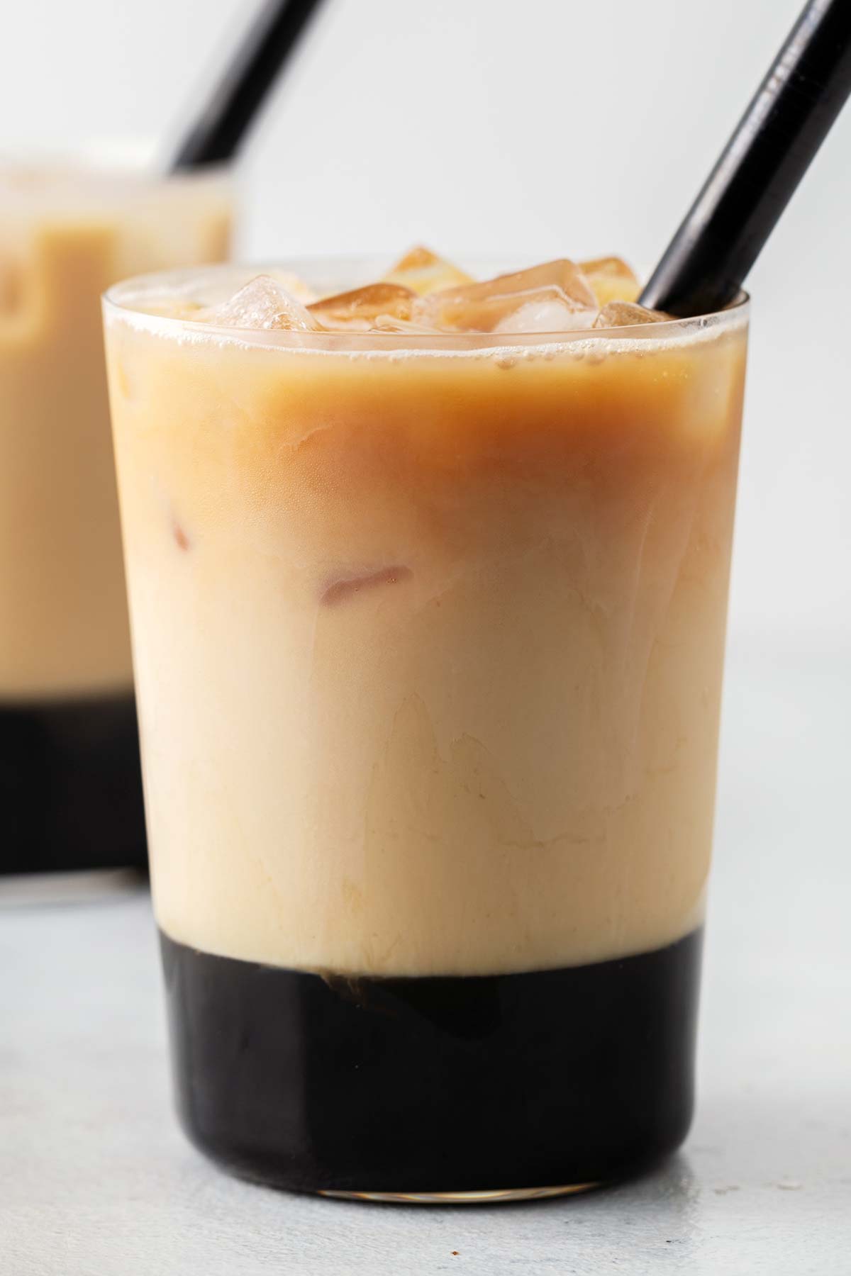 Rose Bubble Tea (Rose Milk Tea with Boba) finished and layered in a large glass with a black, wide straw.