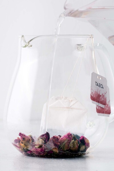 Rose petals and tea bags in a teapot. 