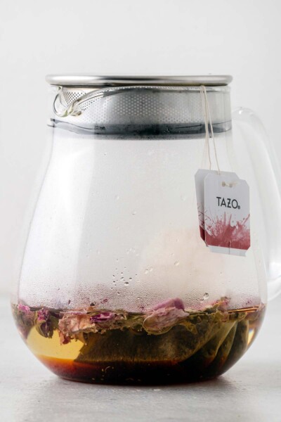 Tea bags and rose petals steeping in teapot. 