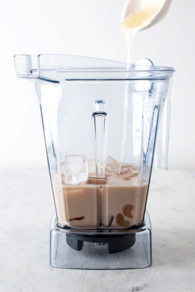 Chai concentrate, milk, ice, and homemade Frappuccino base syrup in a blender. 