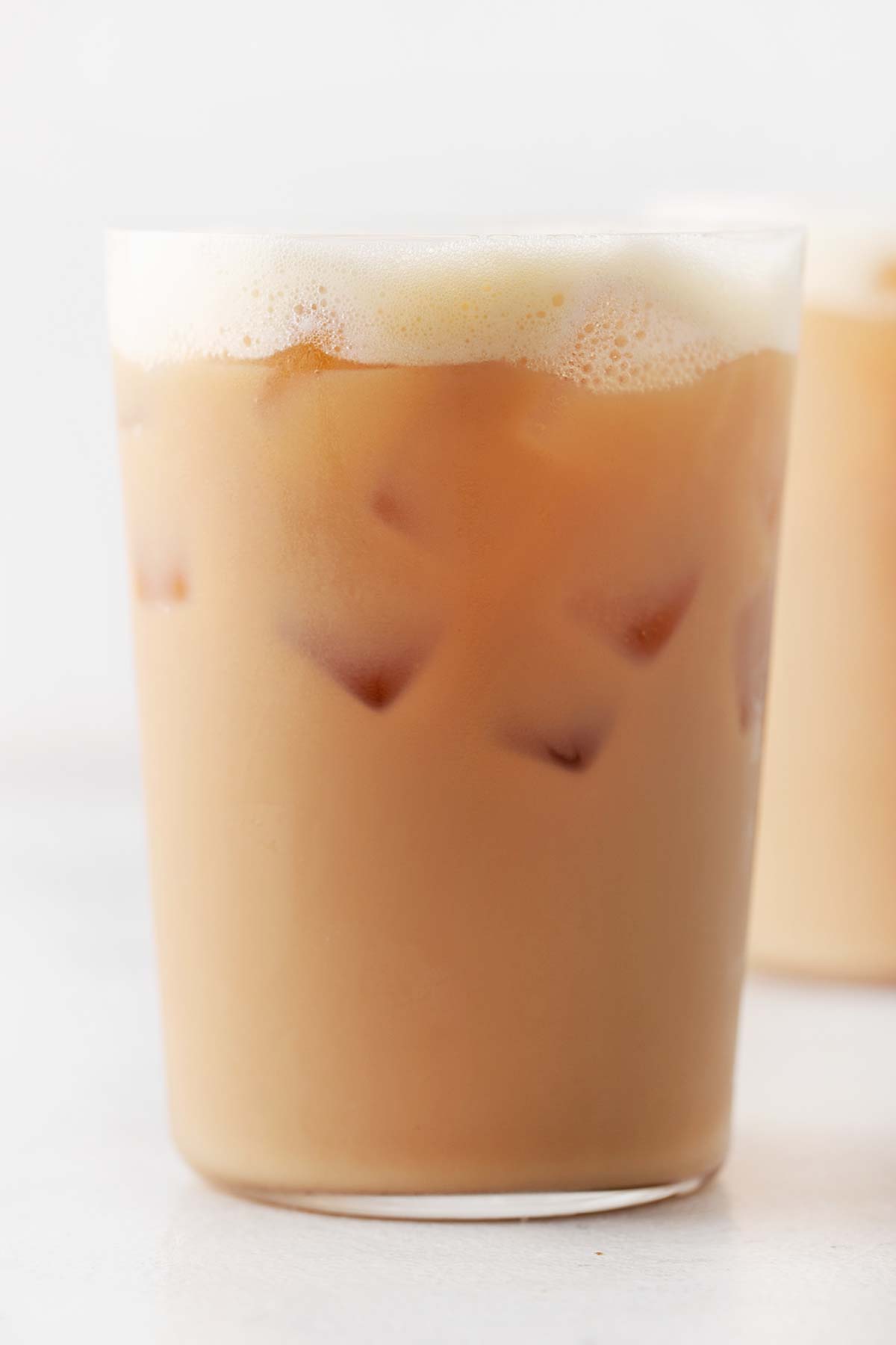 Starbucks Iced Royal English Breakfast Tea Latte Copycat in a tall glass with ice and topped with milk foam.