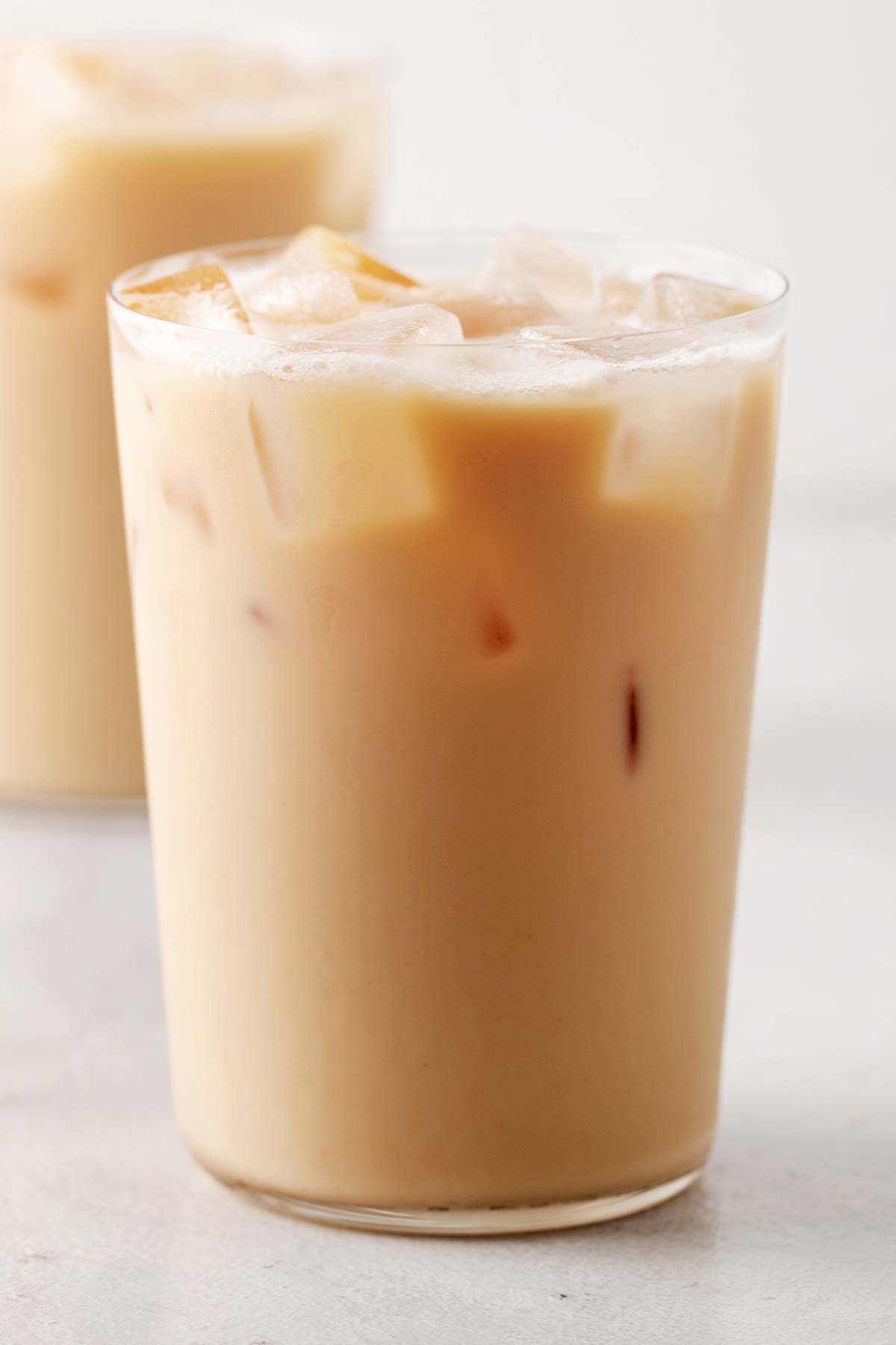 Starbucks Iced London Fog Tea Latte copycat in a clear glass topped with ice.