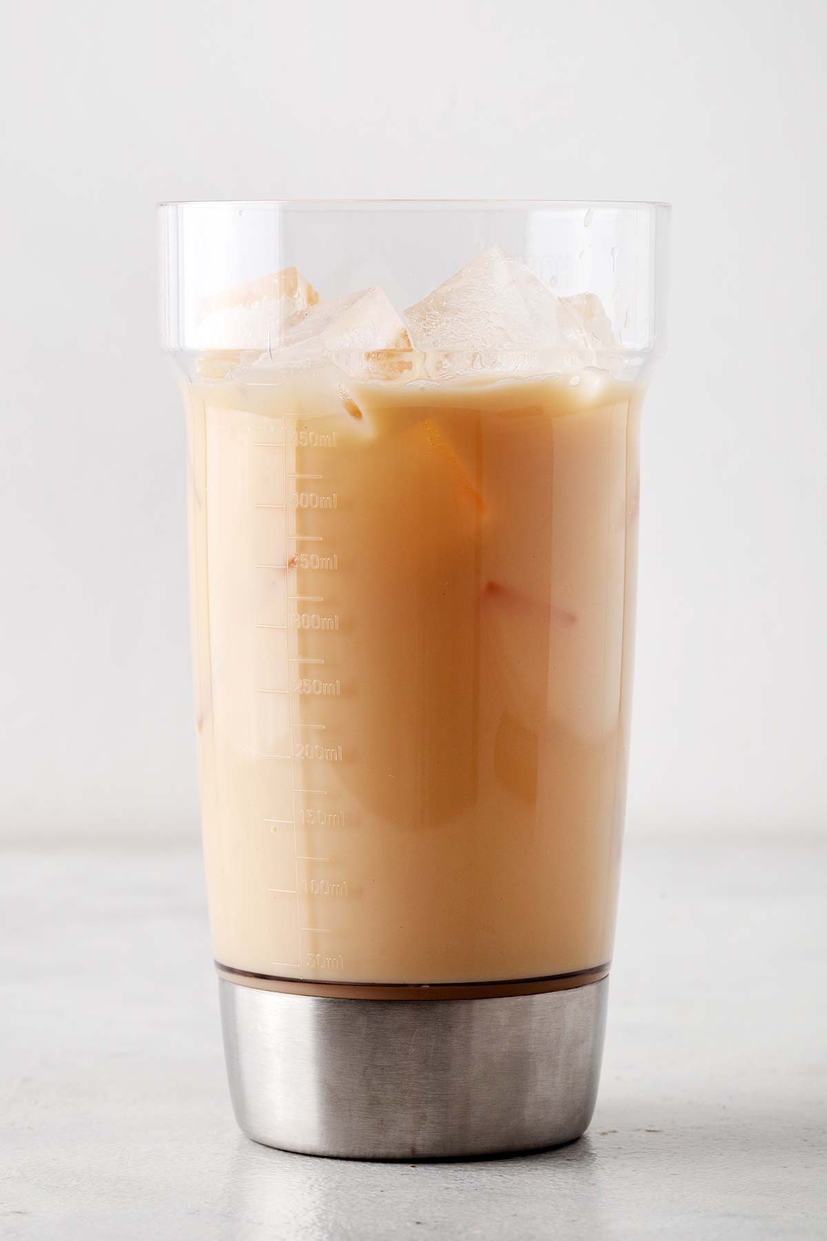 Starbucks Iced London Fog Tea Latte copycat in a clear cocktail shaker with ice.