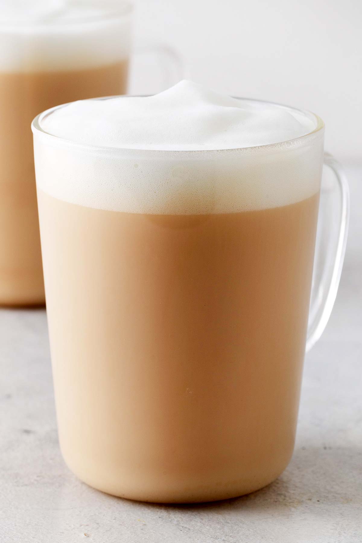 Starbucks London Fog Tea Latte Copycat with foam on top in a clear glass mug.