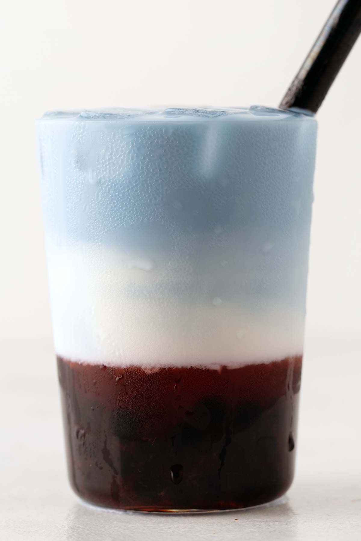 Strawberry and Butterfly Pea Flower Latte Bubble Tea fully layered in red, white, and blue.