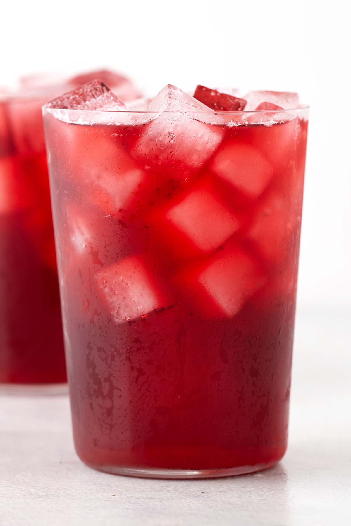 Strawberry Hibiscus Iced Tea in clear cup.