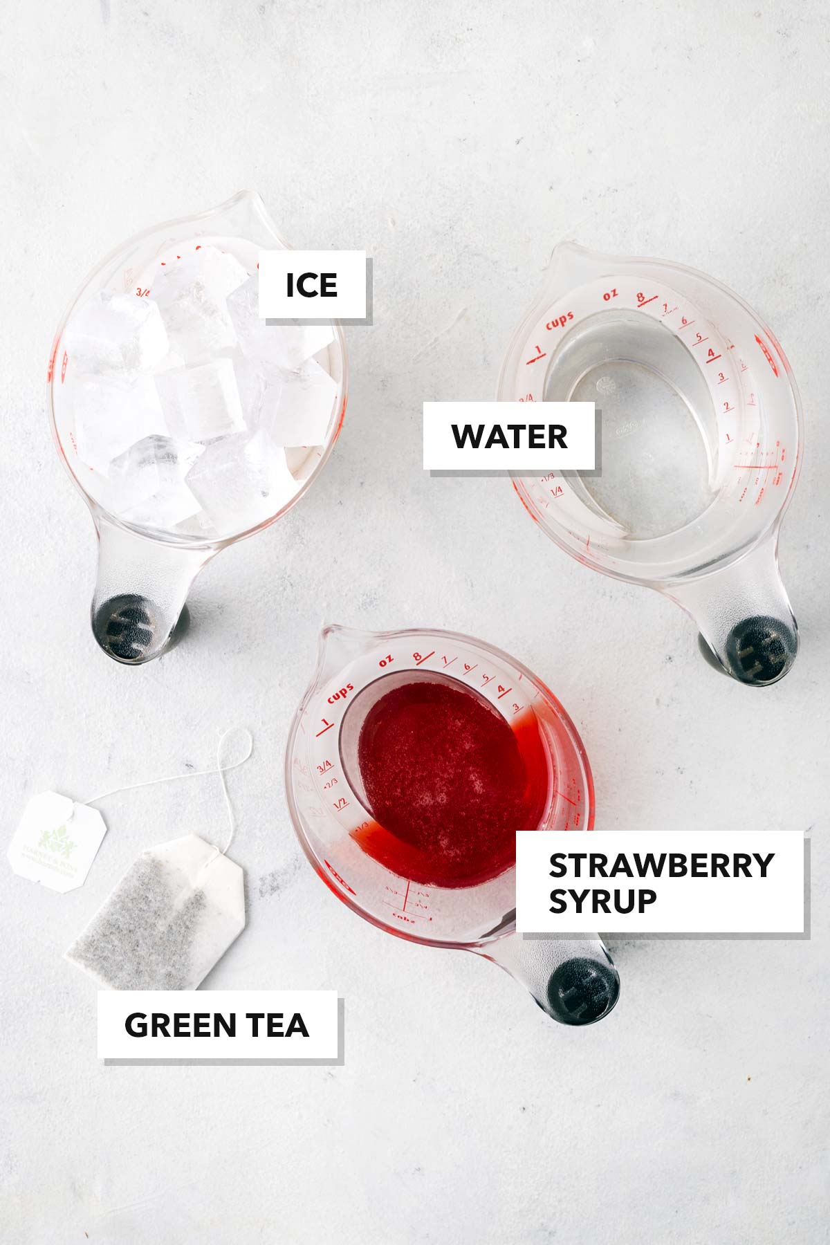 Strawberry Iced Tea ingredients measured in cups and labeled on a table.