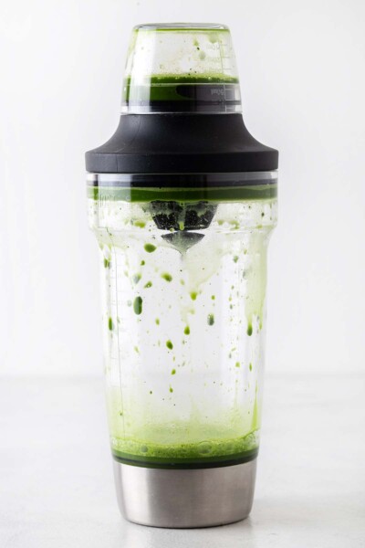 Matcha and water in a cocktail shaker. 